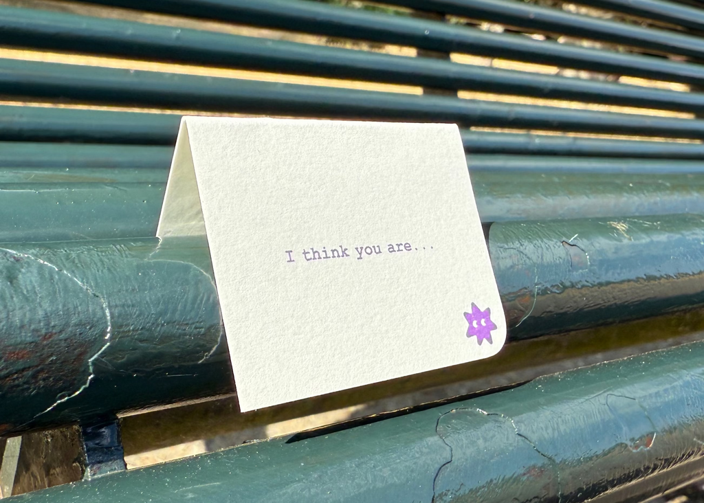 A small folded cream greeting card with printed text reading 'I think you are.